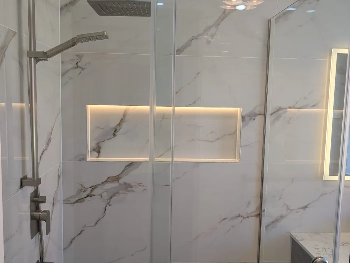 Quakers Hill bathroom after renovation with marble-look walls and frameless shower