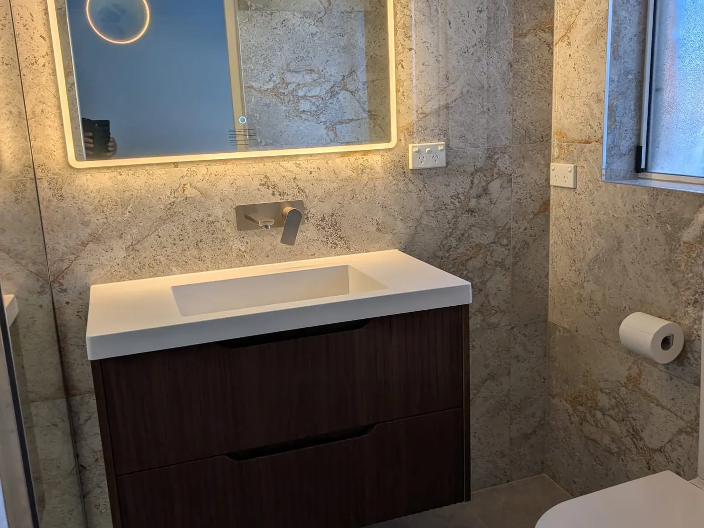 Quakers Hill family bathroom wall-hung timber vanity with backlit round mirror